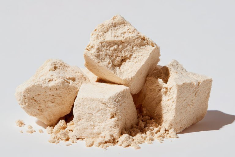 Group of raw dehydrated soy protein chunks on a pristine white background